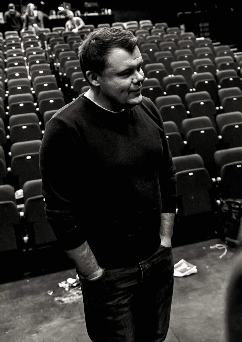 Mark Calvert standing in an empty auditorium